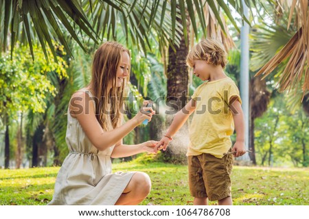 ストックフォト: Mom And Son Use Mosquito Sprayspraying Insect Repellent On Skin Outdoor