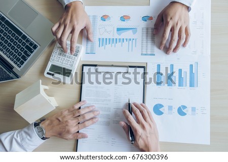 [[stock_photo]]: Man Sign A Home Insurance Policy On Home Loans Agent Holds Loan