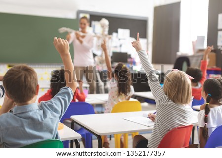 Zdjęcia stock: Male Teacher Explaining Anatomical Model In Classroom Of Elementary School