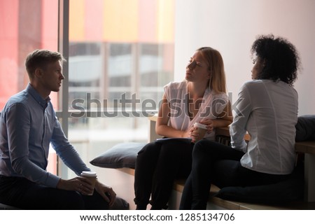 ストックフォト: Two Serious Multicultural Students Listening To Groupmate During Discussion