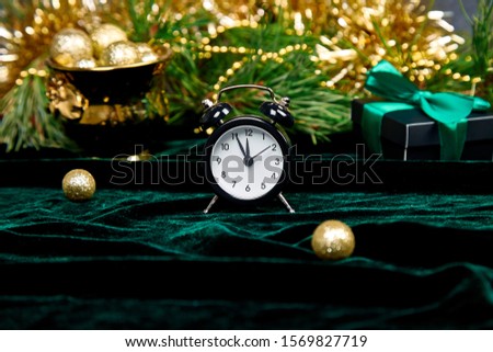 Foto stock: Black Alarm Clock And Fir Tree Branch Gold Christmas Decorations Green Velours