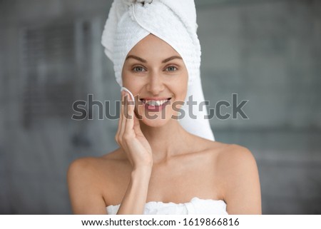 Сток-фото: Pretty Young Smiling Female With Cotton Pad Enjoying Procedure Of Cleaning Face