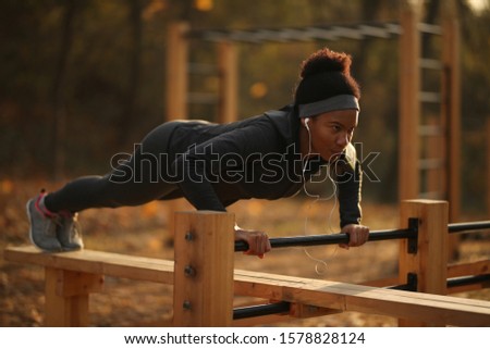 Stock photo: Image Of African American Sportswoman Doing Exercise With Battle Ropes