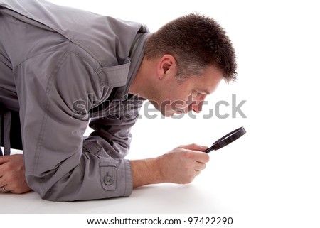 Stock photo: Man With Raincoat Is Looking With Magnifying Glass Over White Ba