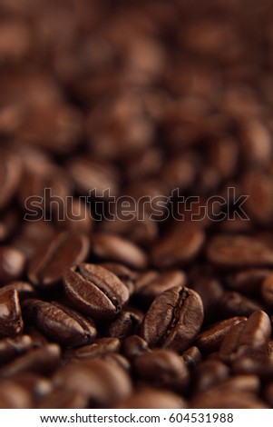 [[stock_photo]]: Roasted Coffee Beans Close Up With Blur Vertical Shot As Background