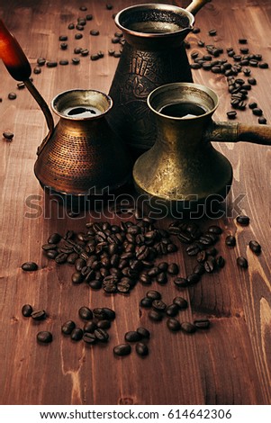 Foto stock: Hot Coffee In Group Shabby Antique Turkish Pots Cezve With Crema Beans With Blur On Brown Old Woode