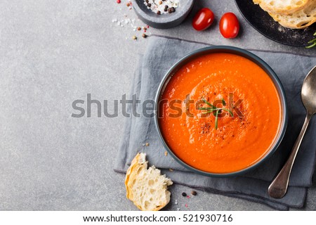 Foto stock: Tomato Soup In A Black Bowl On Grey Stone Background Top View Copy Space