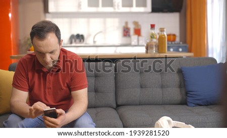 Stock photo: Portrait Of Handsome Seated Young Casual Man Holding His Chin