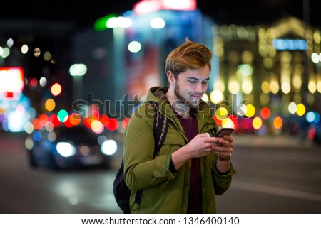 Foto stock: Attractive Young Man Portrait At Night With City Lights Behind Him In Turin Italy