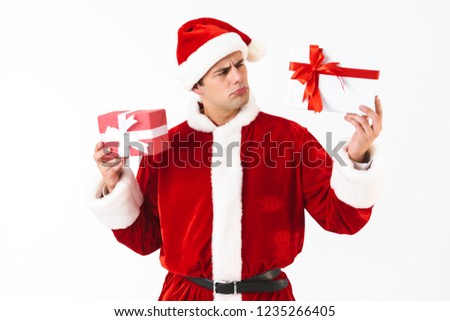 Сток-фото: Portrait Of Amusing Man 30s In Santa Claus Costume And Red Hat H