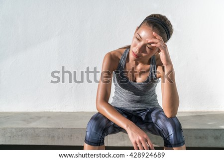 Stock photo: Exhausted Female Runner Sitting With Headache Feeling Exhaustio
