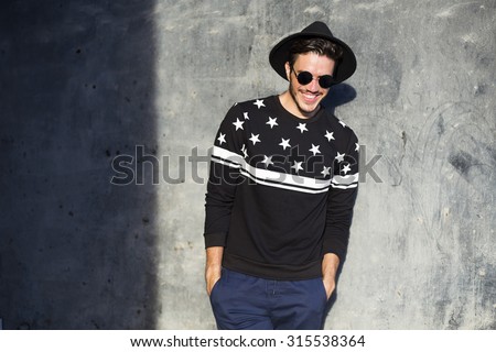 Foto stock: A Young Boy In A Sweater On The Background Of Autumn Dark Forest Guards Orange Pumpkins