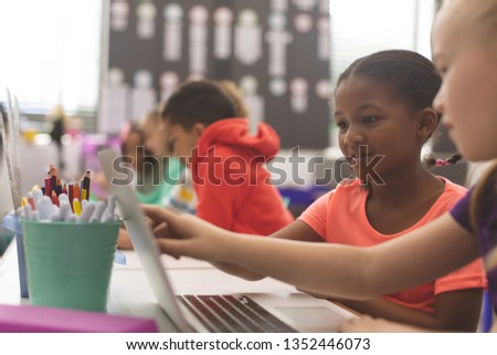 Stock fotó: Side View Of Mixte Ethnicity School Kids Sitting On Cushions And Studying Over Books In A Library At