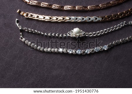 Stockfoto: Golden Bracelets Earrings Rings Jewelery On Gold Water Backgr