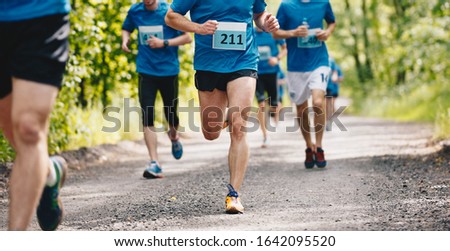 Group Of Runners Running Fast Through The Forest On Trail Marath Stockfoto © matimix