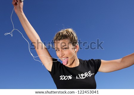 Stock fotó: Funny Woman Listening To Music Outdoors Through Digital Player