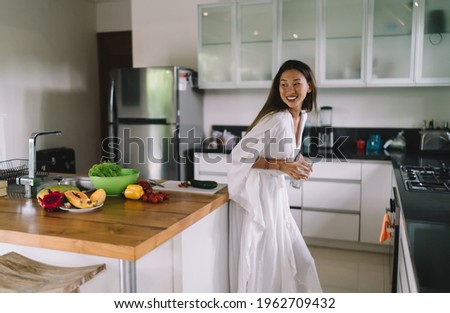 Foto stock: Young Female Leaning Forward While Drinking A Glass Of White Wine