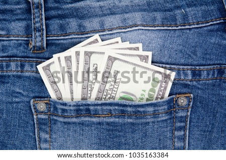 Stok fotoğraf: A Hundred Dollar Bills Sticking In The Back Pocket Of Denim Blue