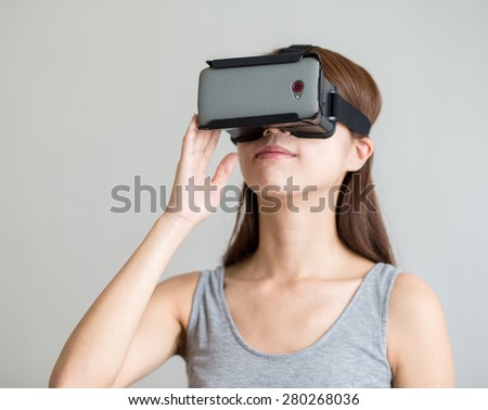 Foto stock: Pretty Young Lady Wearing Virtual Reality Device Holding Joysticks