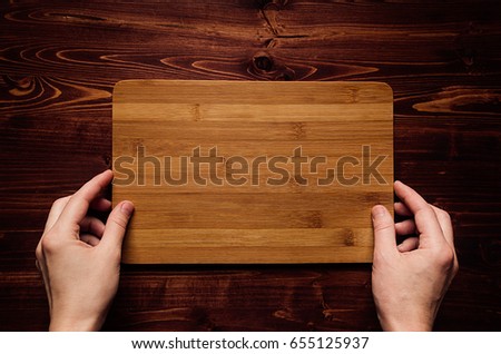 Stock photo: Hand Hold Blank Bamboo Sign Board On Brown Vintage Wood Plank Top View Mock Up For Company Identit