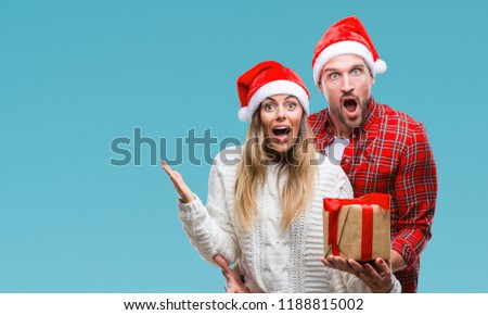 ストックフォト: Excited Happy Young Loving Couple Wearing Christmas Hats Drinking Champagne