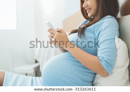 Stock fotó: Happy Casual Pregnant Woman At Home Touching Her Belly Professional Entrepreneur Success During Pre