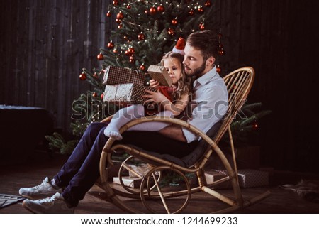 Stok fotoğraf: Stylish Young Man Sitting On Wooden Box While Holding Glasses