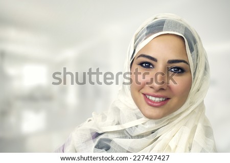 Stock photo: Portrait Of Beautiful Serious Young Muslim Woman Wearing Black Hijab With Hands Near Her Face As Pra