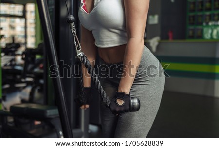 ストックフォト: Determined Young Woman Exercising Cable Rope Triceps Extension