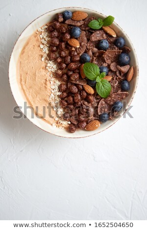 Stockfoto: Chocolate And Blueberry Smoothie Or Yogurt With Cocoa Cornflakes Granola Mint Leaves And Almonds