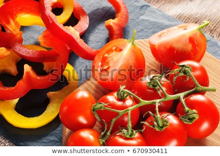 Foto d'archivio: Sliced Red And Yellow Bell Peppers On Wooden Board