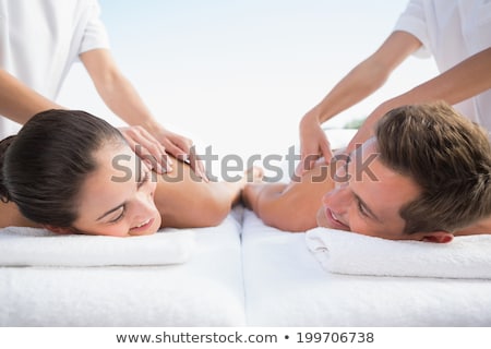 ストックフォト: Content Couple Enjoying Head Massages Poolside
