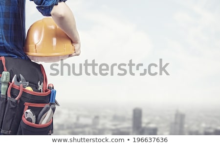 Foto stock: Worker With Toolbelt And Helmet