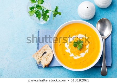 Сток-фото: Pumpkin And Carrot Soup With Cream On Blue Stone Background