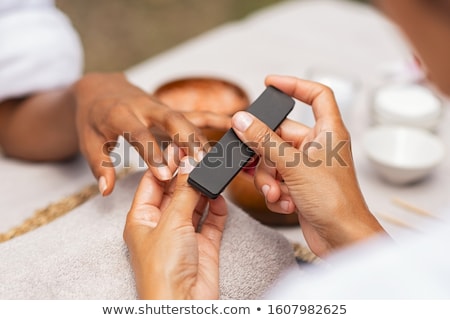 Foto d'archivio: Woman In Nail Salon Receiving Manicure By Beautician