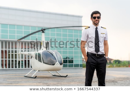 Stockfoto: Young Man In Small Plane Cockpit Outdoors