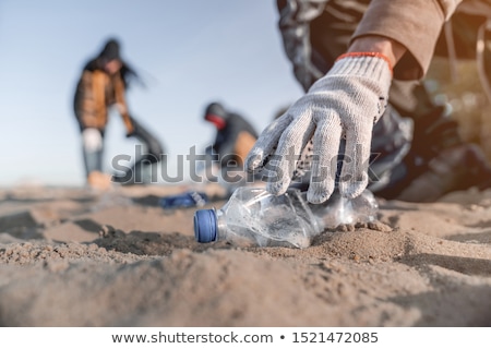 Stockfoto: Collecting Plastic Bottles At The Beach