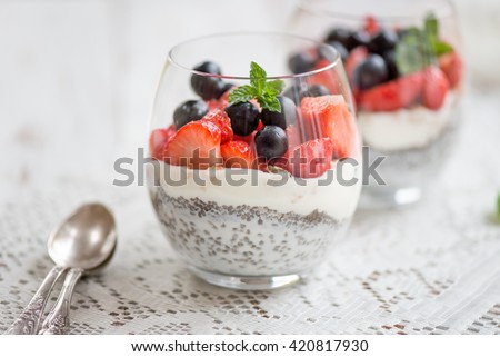 Zdjęcia stock: Healthy Layered Dessert With Chia Pudding Strawberry And Honeysuckle In A Mason Jar On Rustic Backg