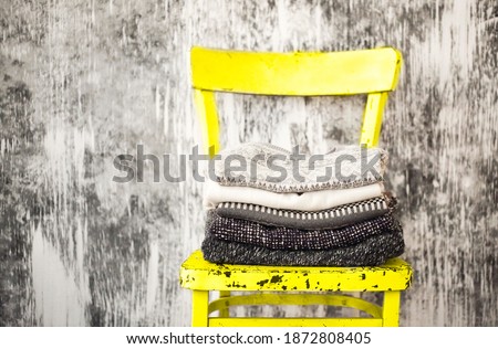 [[stock_photo]]: Pile Of Knitted Warm Grey And White Blankets Scarves And Woolen