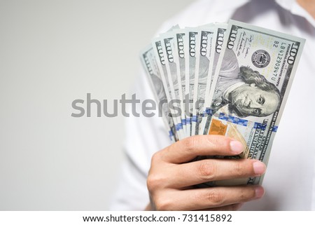 ストックフォト: Hand Holding Money Fan One Hundred Dollar Bills On A Gray Background Banknote Close Up The Offer