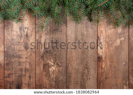 [[stock_photo]]: Christmas Tree Branches On Wooden Texture Ready For Your Design