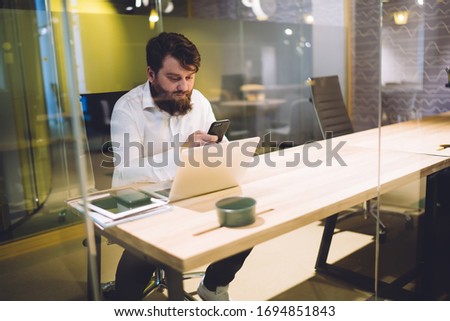 Foto stock: Male Executive Using Glass Mobile Phone Against White Background