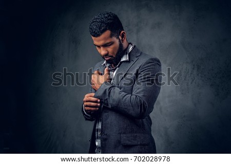 Stockfoto: Stylish Trendy Businessman In A Business Suit On A Black Backgr