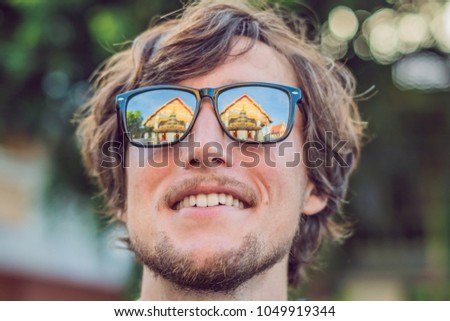 Foto stock: Male Tourist Looking At Thai Temple In Phuket Town Wat Mongkolnimit