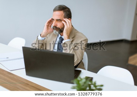 Stok fotoğraf: Mature Businessman In Classic Suit Having A Headache While Work