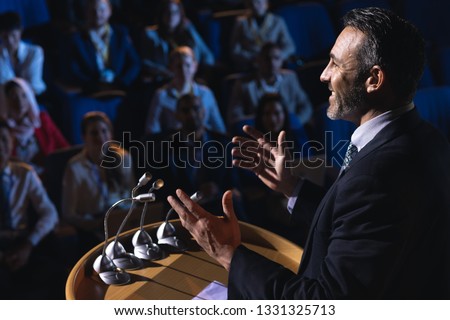 Stock fotó: Side View Of Caucasian Businessman Standing And Giving Presentation In The Auditorium