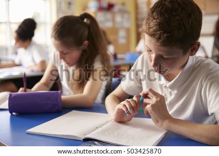 Foto stock: Two Girls Of Primary School Schoolgirls Read A Book In The Courtyard Of The Academy