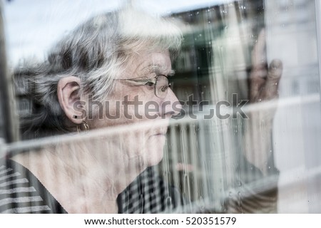 Senior Woman Looking Out Through A Window Like Depress ストックフォト © Lopolo