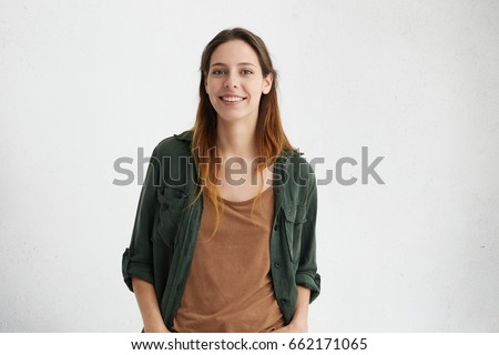 Stok fotoğraf: Photo Of Pleased Brunette Woman Smiling While Looking At Camera