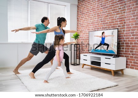 ストックフォト: Tv Yoga At Home Fitness Class Woman Meditating Stretching Hands Watching Live Streaming Video Class